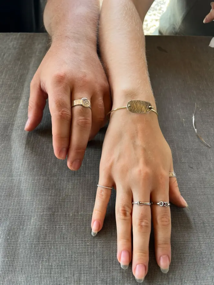 Finished rings and bracelet worn on two hands