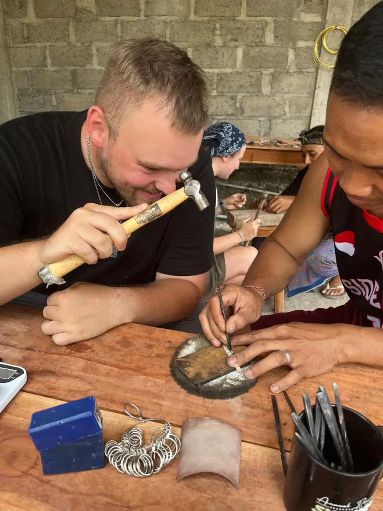 Student hammering silver at the bench